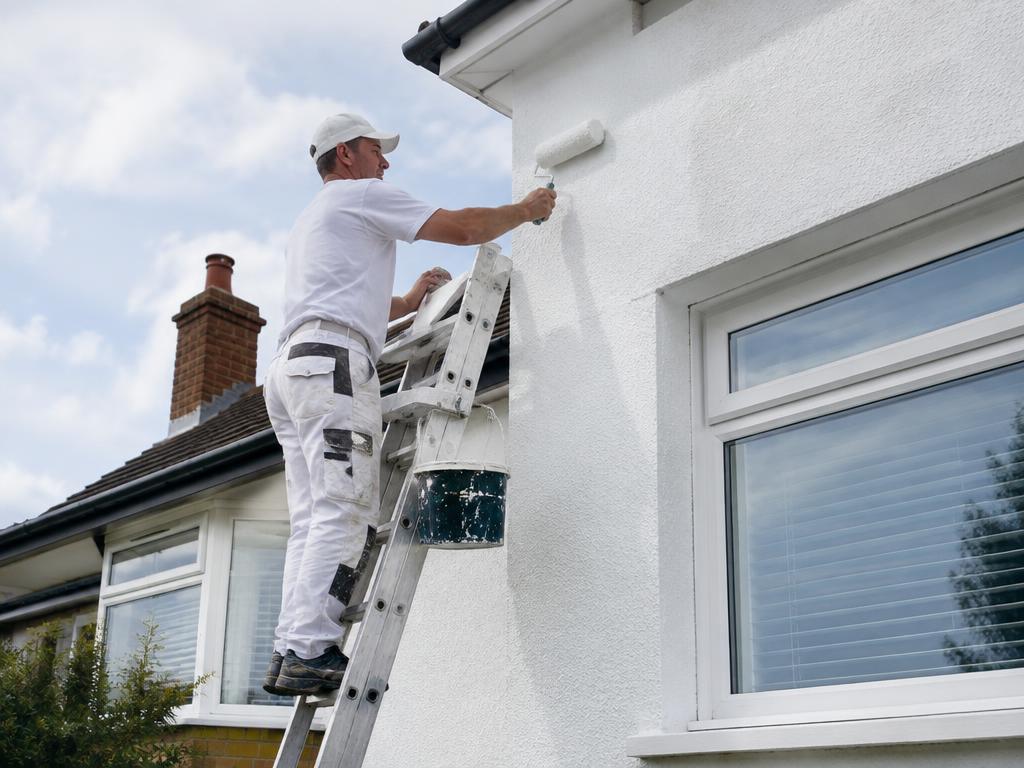 Painter decorating the exterior of a house